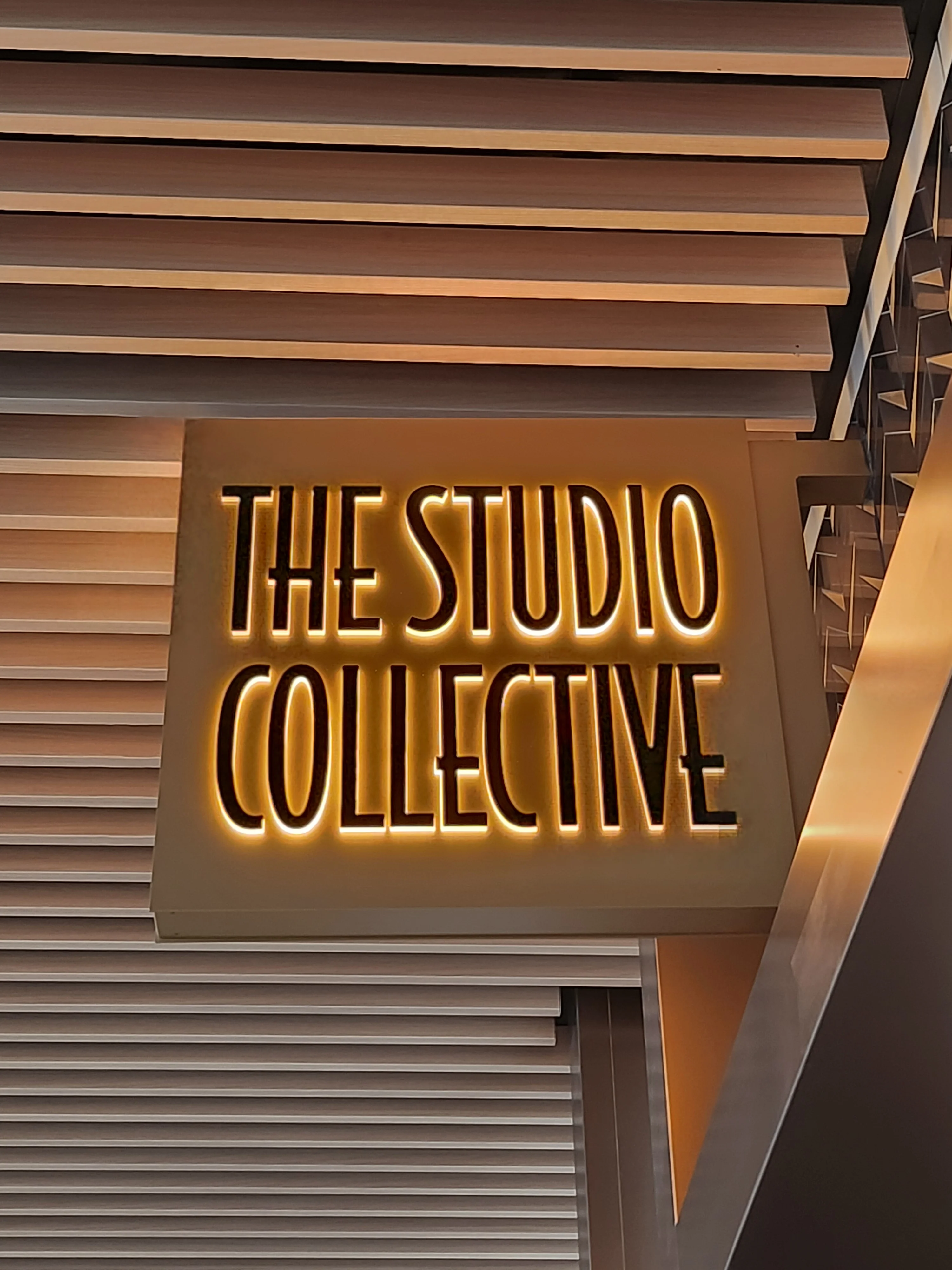 A backlit sign for The Studio Collective, one of the terminal's new retail shops